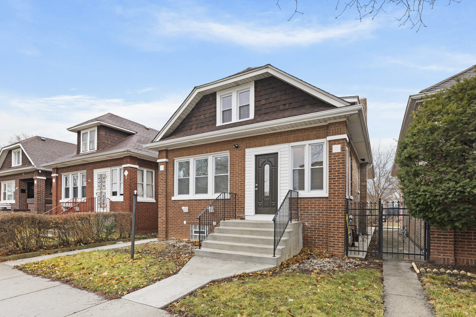 8946 South May Street Chicago, IL 60620 - Photo 3 of 23 a front view of a house with a yard