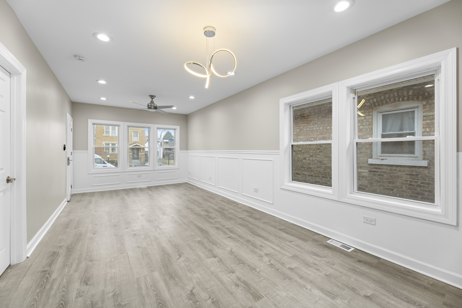 8946 South May Street Chicago, IL 60620 - Photo 6 of 23 an empty room with wooden floor and windows