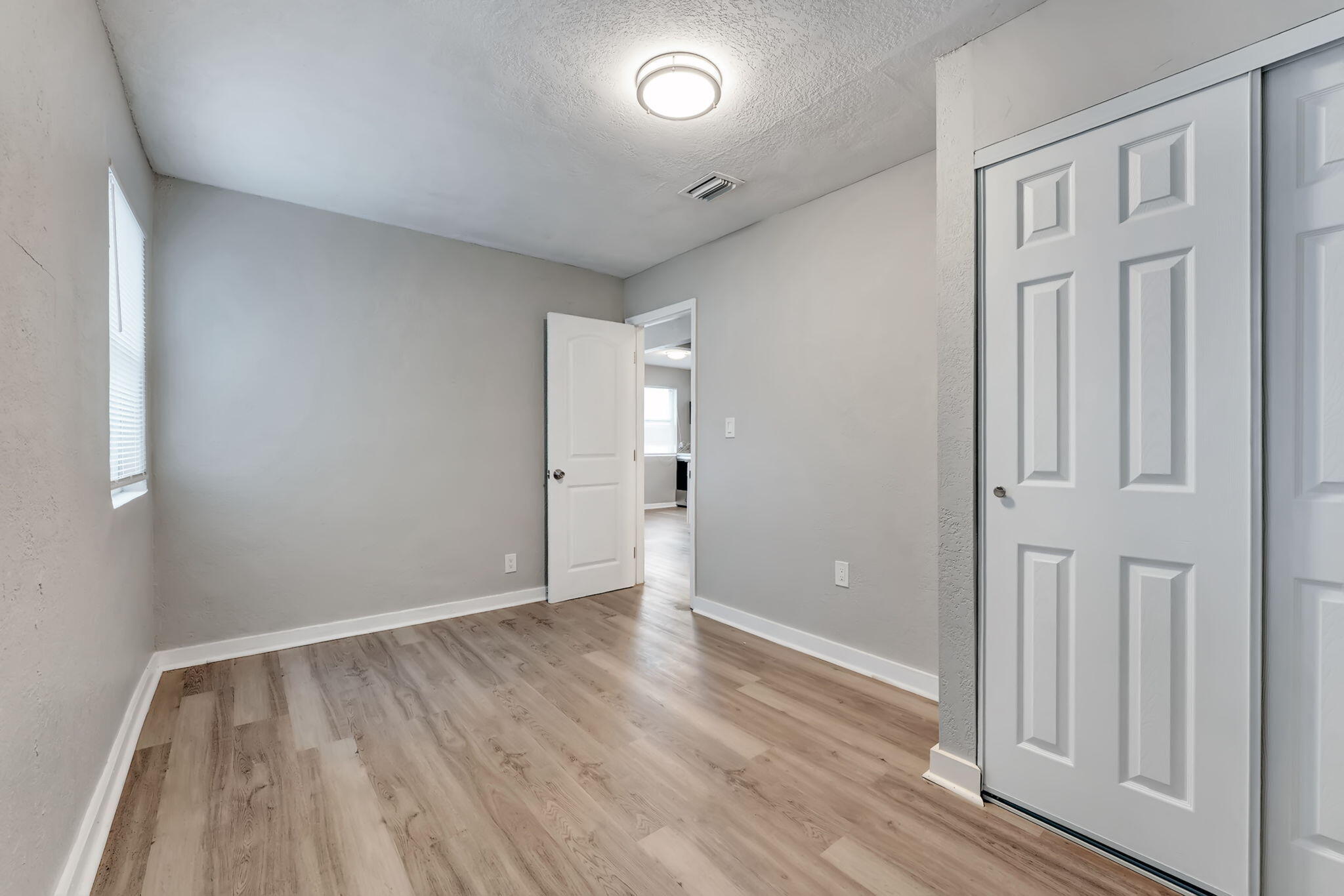 172 West 15th Street, Unit 1 Riviera Beach, FL 33404 - Photo 14 of 23 wooden floor in an empty room with a window