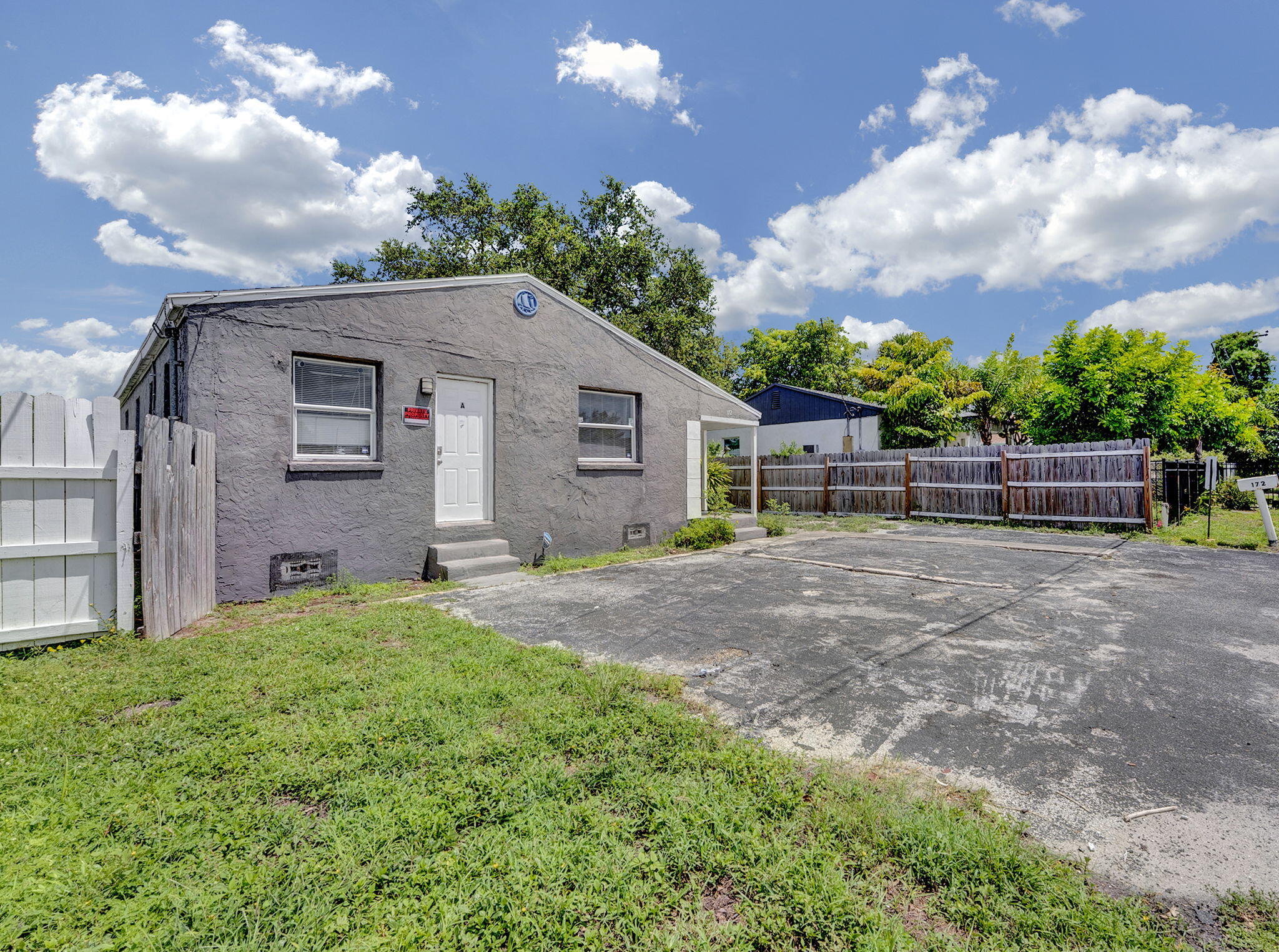 172 West 15th Street, Unit 1 Riviera Beach, FL 33404 - Photo 21 of 23 a backyard of a house with lots of green space