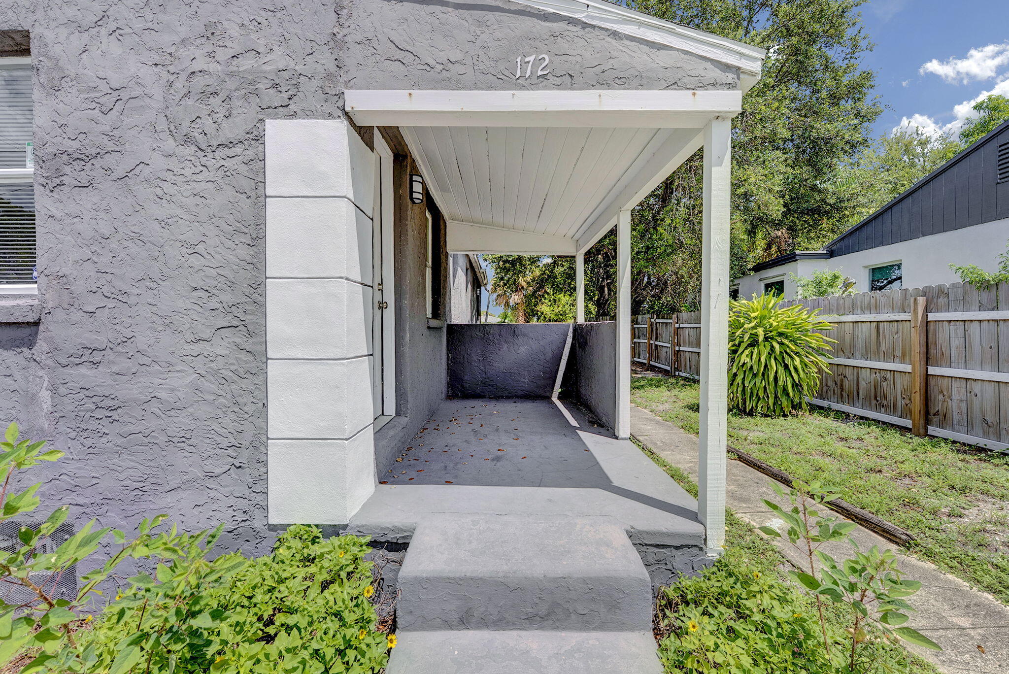 172 West 15th Street, Unit 1 Riviera Beach, FL 33404 - Photo 22 of 23 a view of a patio with table and chairs potted plants
