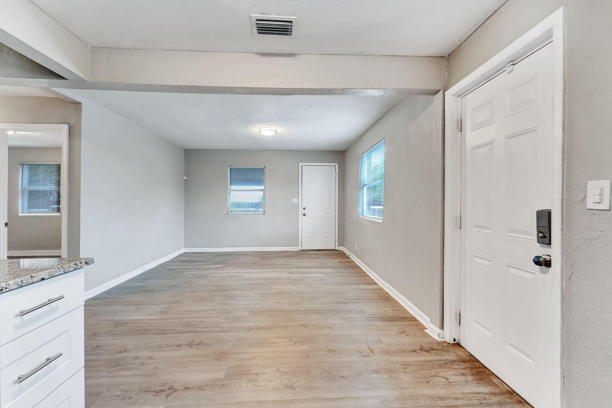 172 West 15th Street, Unit 1 Riviera Beach, FL 33404 - Photo 3 of 23 a view of empty room with wooden floor and fan