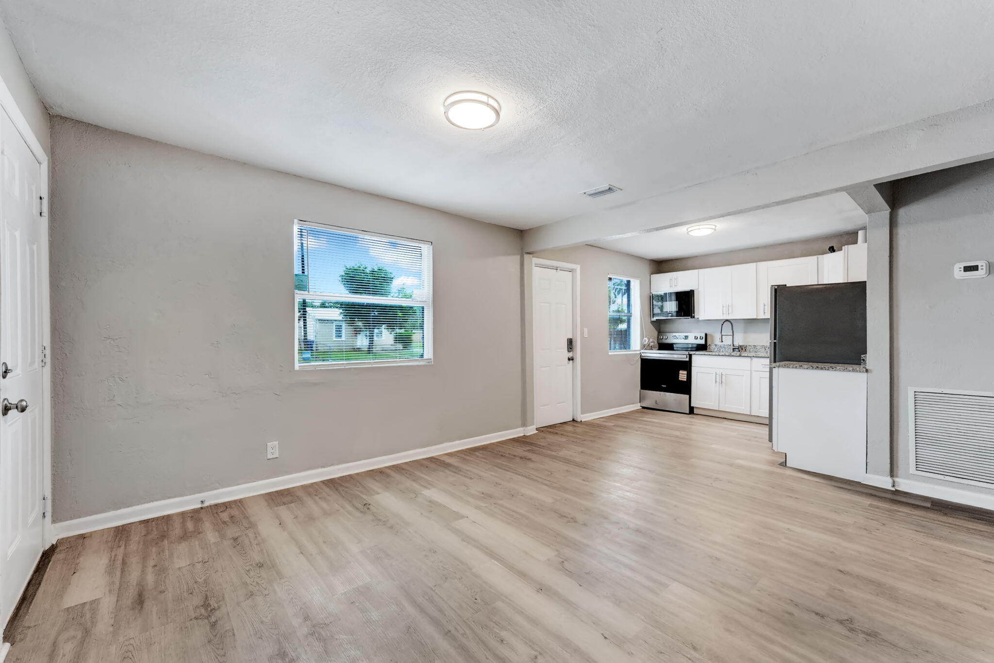 172 West 15th Street, Unit 1 Riviera Beach, FL 33404 - Photo 5 of 23 a view of kitchen with stainless steel appliances kitchen island refrigerator stove and oven