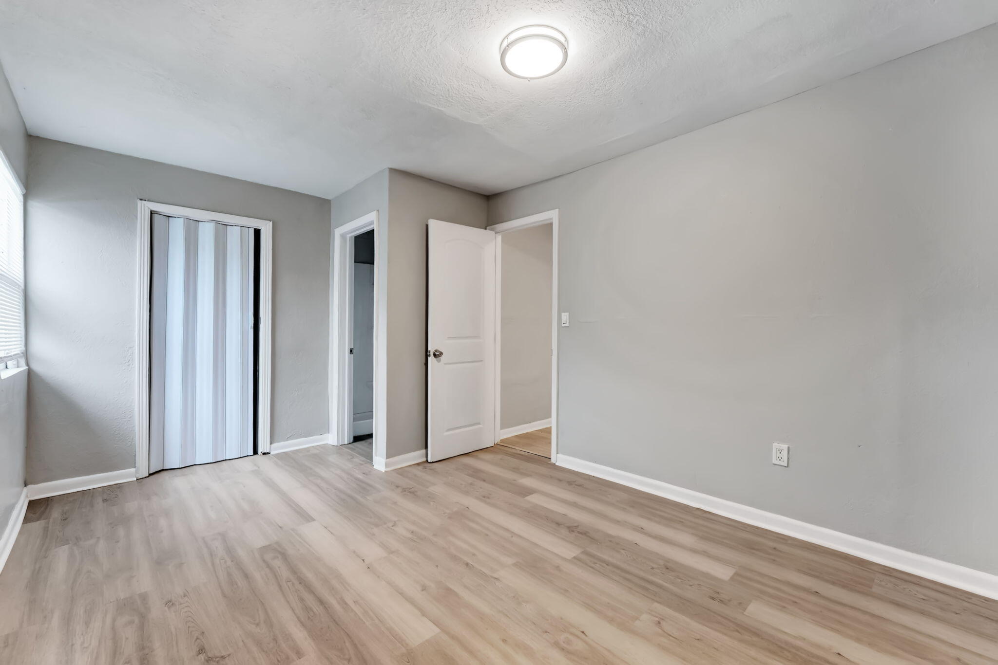 172 West 15th Street, Unit 1 Riviera Beach, FL 33404 - Photo 10 of 23 an empty room with wooden floor and windows