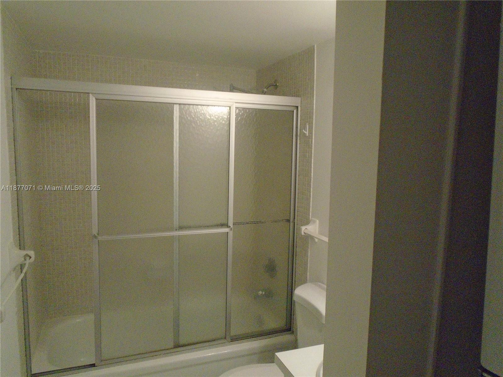 4174 Inverrary Drive, Unit 303 Lauderhill, FL 33319 - Photo 15 of 27 a bathroom with a shower and a toilet