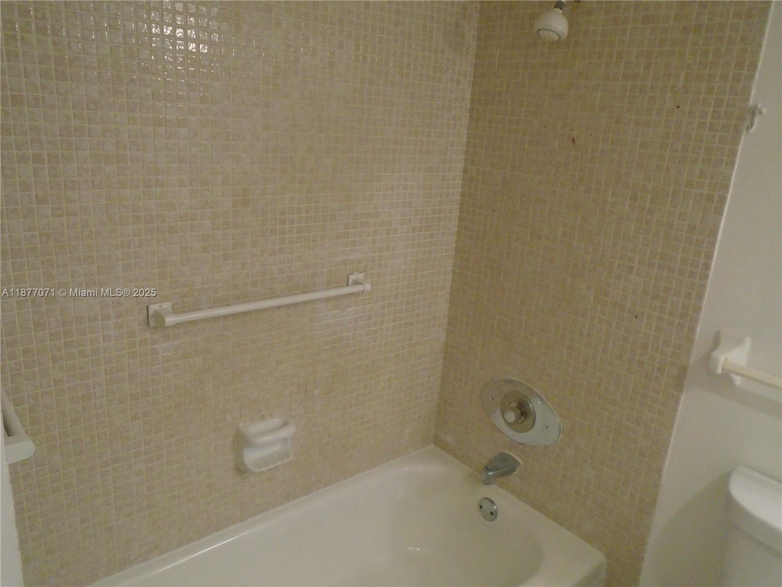4174 Inverrary Drive, Unit 303 Lauderhill, FL 33319 - Photo 24 of 27 a bathroom with a bathtub