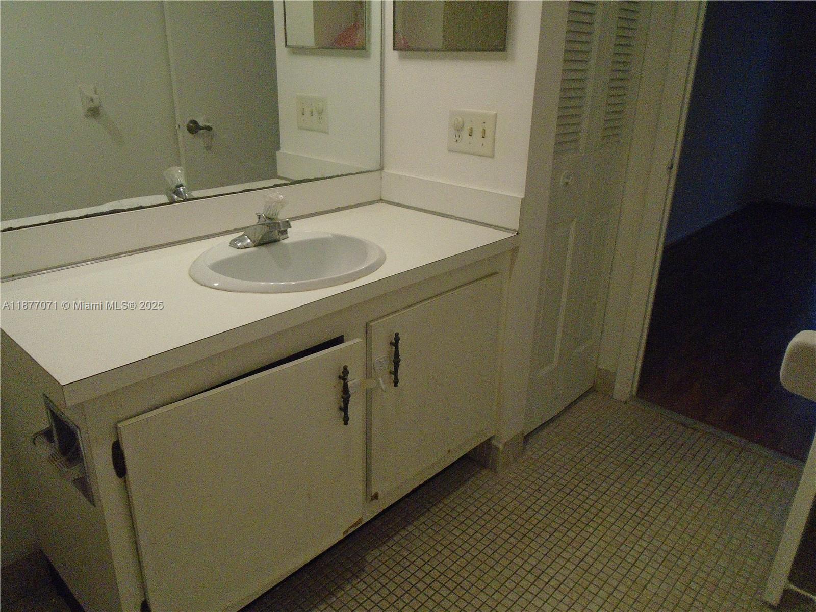 4174 Inverrary Drive, Unit 303 Lauderhill, FL 33319 - Photo 25 of 27 a bathroom with a sink and a toilet