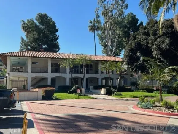 a view of a house with a yard and sitting area