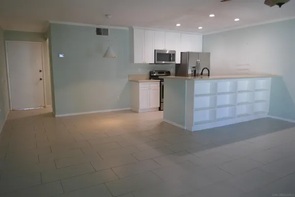 a kitchen with stainless steel appliances a refrigerator and a stove top oven