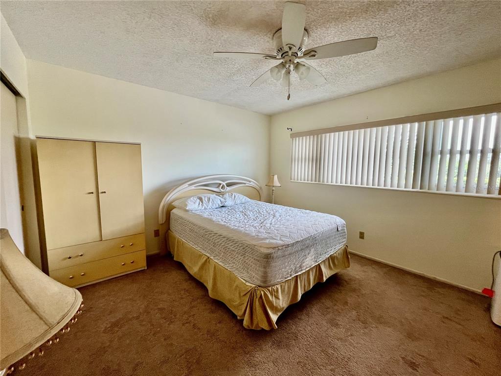 2292 Costa Rican Drive, Unit 22 Clearwater, FL 33763 - Photo 21 of 44 a bedroom with a bed and a table