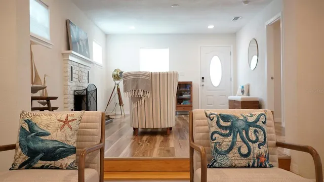 a living room with furniture a flat screen tv and a window