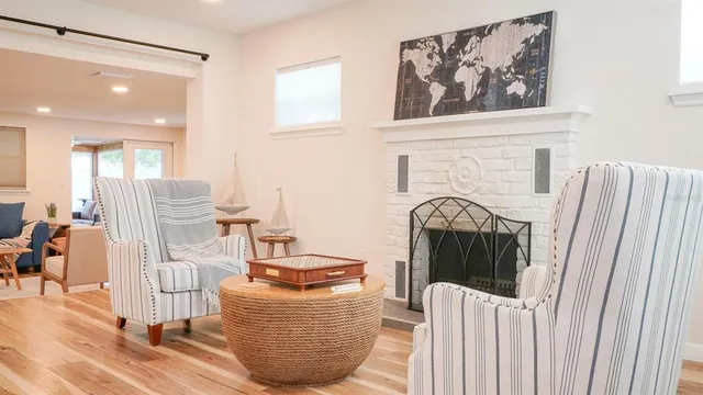 a kitchen with white cabinets and sink