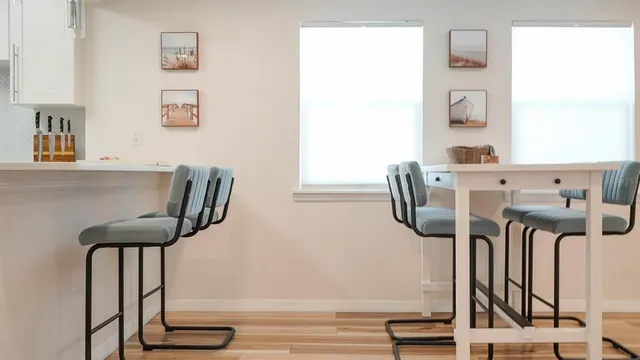 a kitchen with white cabinets and appliances