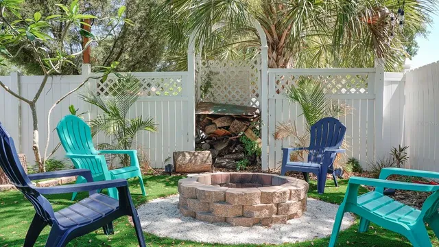 a backyard of a house with table and chairs