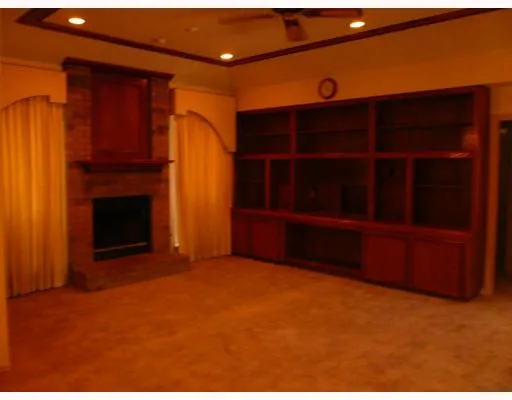 a view of an empty room with a fireplace
