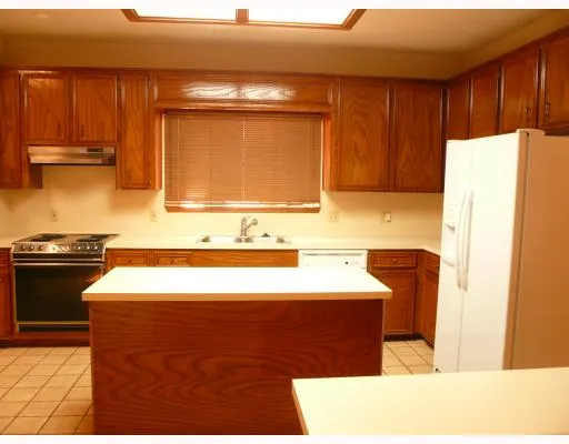 a room with a refrigerator and a stove