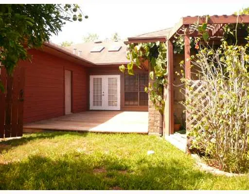a view of house with backyard and shower