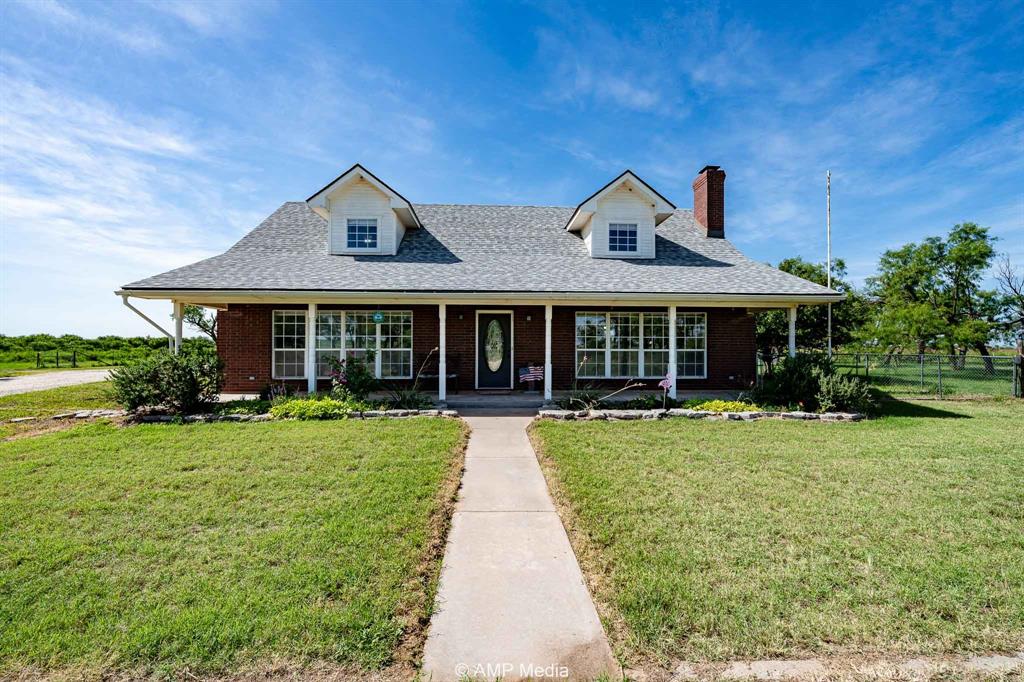 a front view of a house with yard and green space