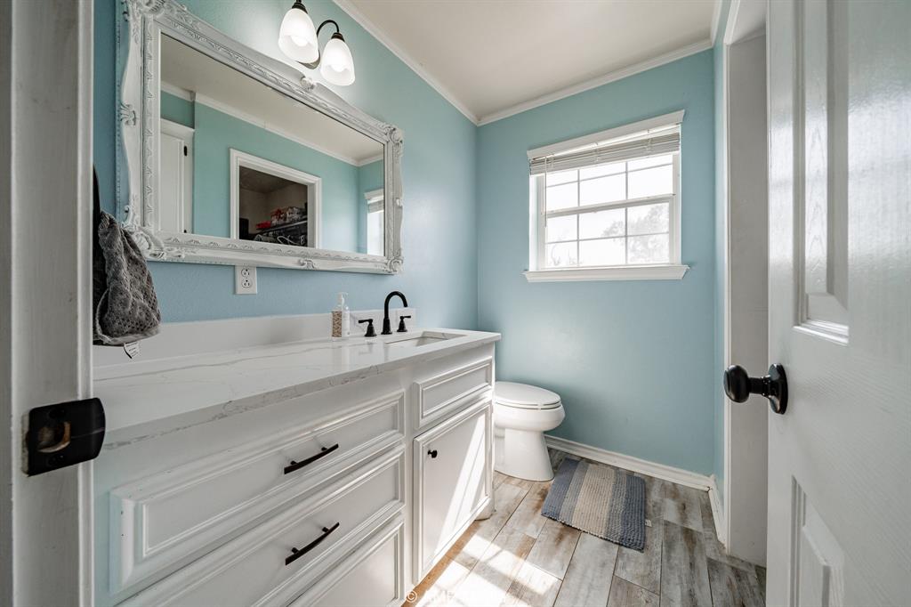 1869 Farm To Market Road 605 Hawley, TX 79525 - Photo 12 of 39 a bathroom with a sink and a mirror