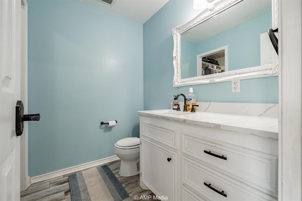 1869 Farm To Market Road 605 Hawley, TX 79525 - Photo 14 of 39 a bathroom with a sink toilet and vanity