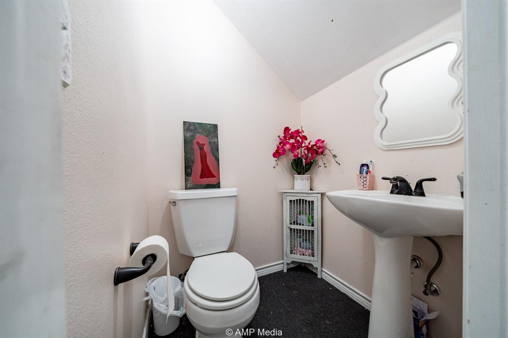 1869 Farm To Market Road 605 Hawley, TX 79525 - Photo 20 of 39 a bathroom with a sink mirror toilet and vanity