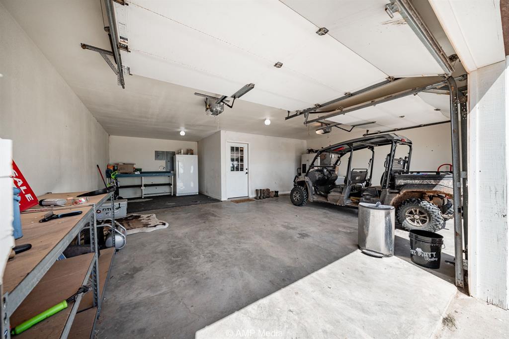 1869 Farm To Market Road 605 Hawley, TX 79525 - Photo 21 of 39 a view of a garage with a bike and a window