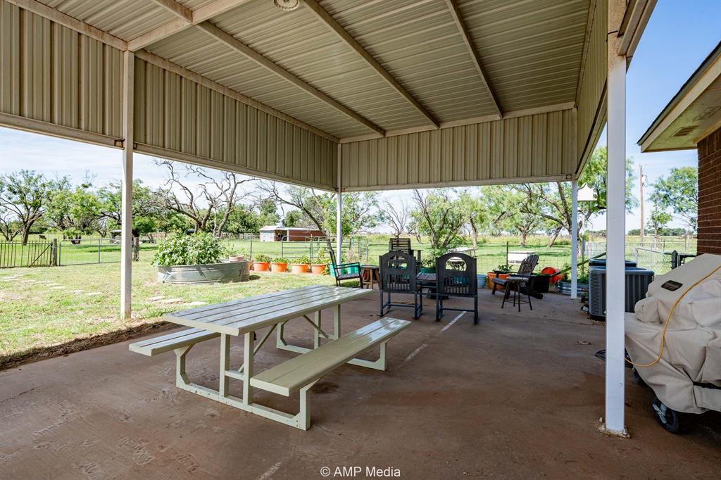 1869 Farm To Market Road 605 Hawley, TX 79525 - Photo 22 of 39 a view of a porch with chairs and backyard