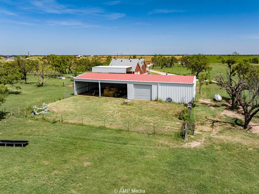1869 Farm To Market Road 605 Hawley, TX 79525 - Photo 32 of 39 a view of a city with lawn chairs under an umbrella