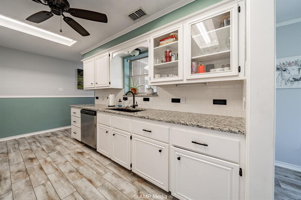 1869 Farm To Market Road 605 Hawley, TX 79525 - Photo 6 of 39 a kitchen with stainless steel appliances granite countertop a sink and cabinets