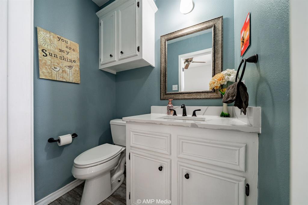 1869 Farm To Market Road 605 Hawley, TX 79525 - Photo 8 of 39 a bathroom with a toilet sink and mirror
