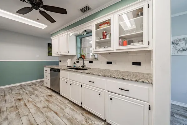 a kitchen with stainless steel appliances granite countertop a sink and cabinets