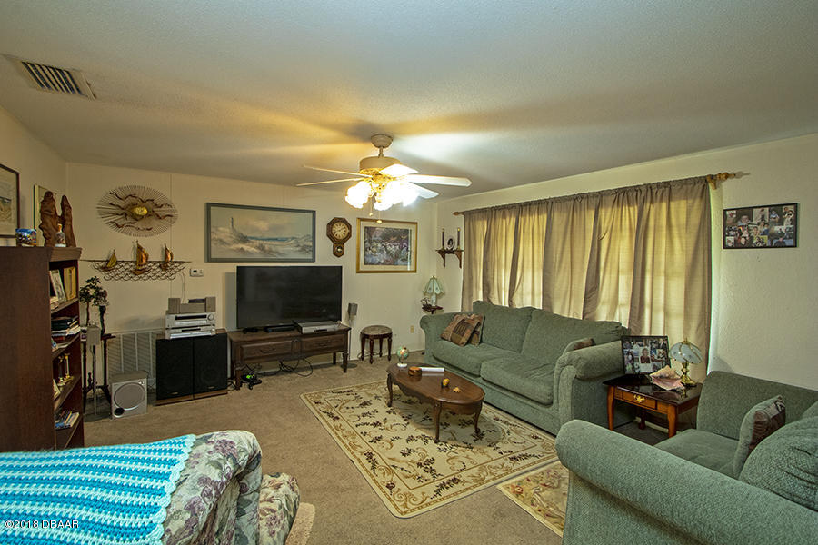 1011 Cherokee Ranch Road Holly Hill, FL 32117 - Photo 14 of 26 1011-Cherokee-Ranch-LivingRoom-Web_0342