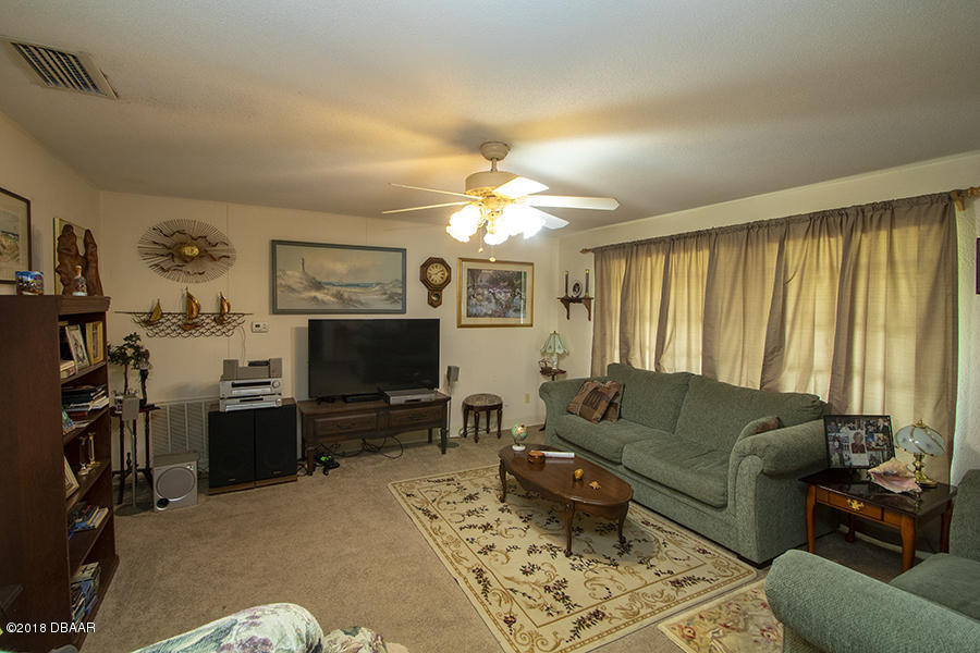 1011 Cherokee Ranch Road Holly Hill, FL 32117 - Photo 15 of 26 1011-Cherokee-Ranch-LivingRoom-Web_0343