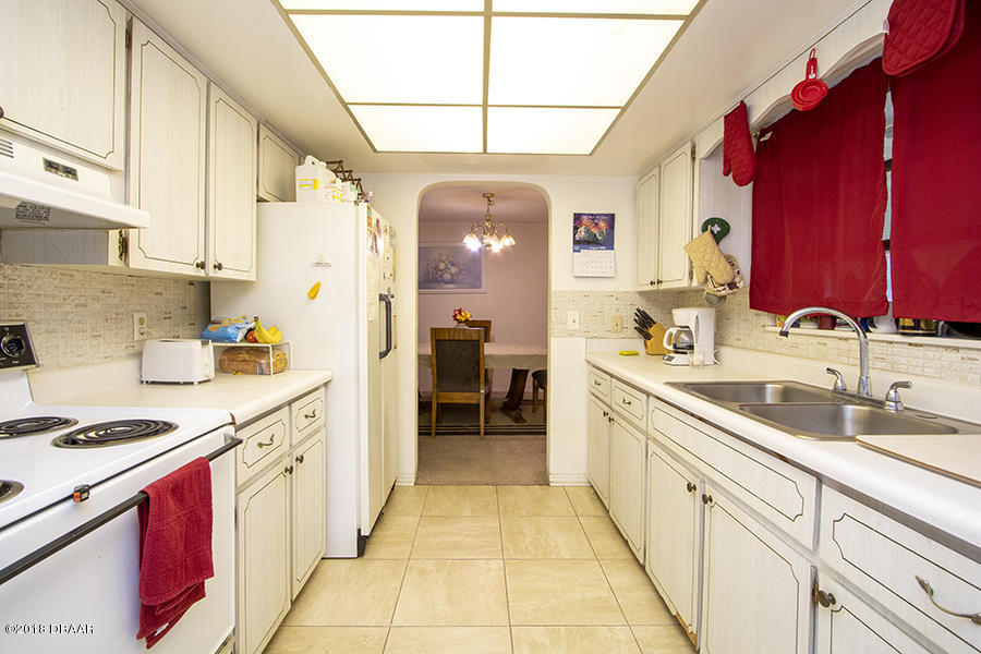 1011 Cherokee Ranch Road Holly Hill, FL 32117 - Photo 22 of 26 1011-Cherokee-Ranch-Kitchen-Web_0392