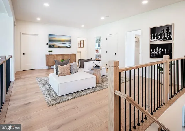a living room with furniture wooden floor and a flat screen tv