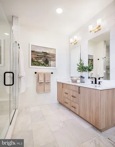 a spacious bathroom with a double vanity sink a large mirror and a bathtub