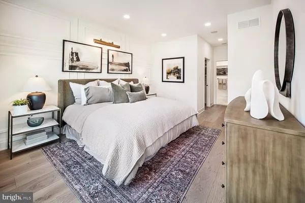 a bedroom with bed and wooden floor