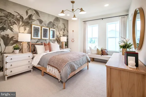 a spacious bedroom with a large bed and a chandelier