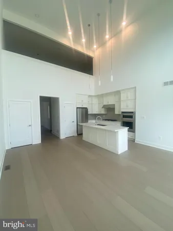 a large white kitchen with cabinets and a fireplace