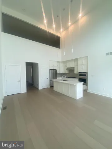 a large white kitchen with cabinets and a fireplace