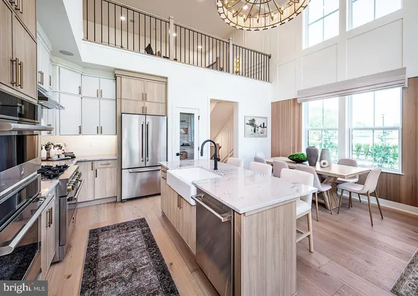 a kitchen with stainless steel appliances granite countertop a stove a sink dishwasher and a refrigerator