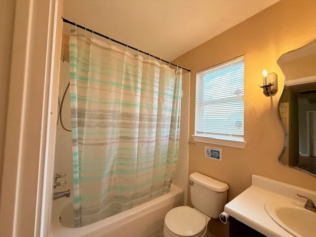 a bathroom with a shower curtain and a sink