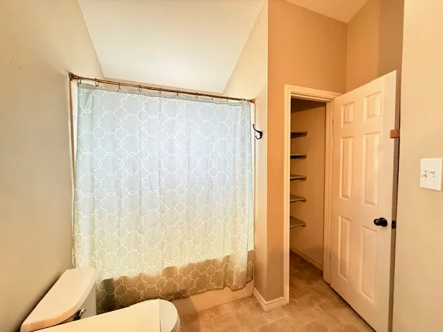 a bathroom with a toilet tub and shower