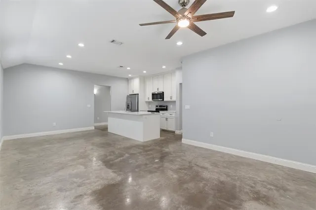 a view of a kitchen with a sink and cabinets