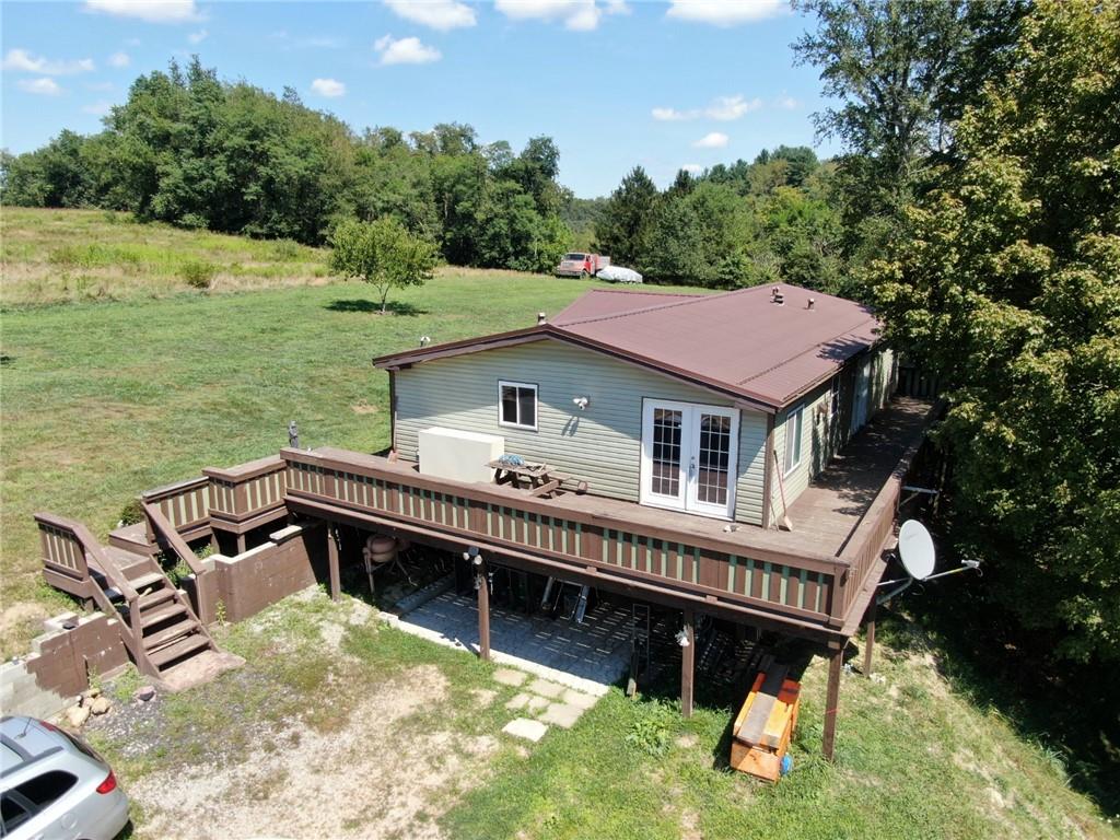 a view of a house with pool and a yard