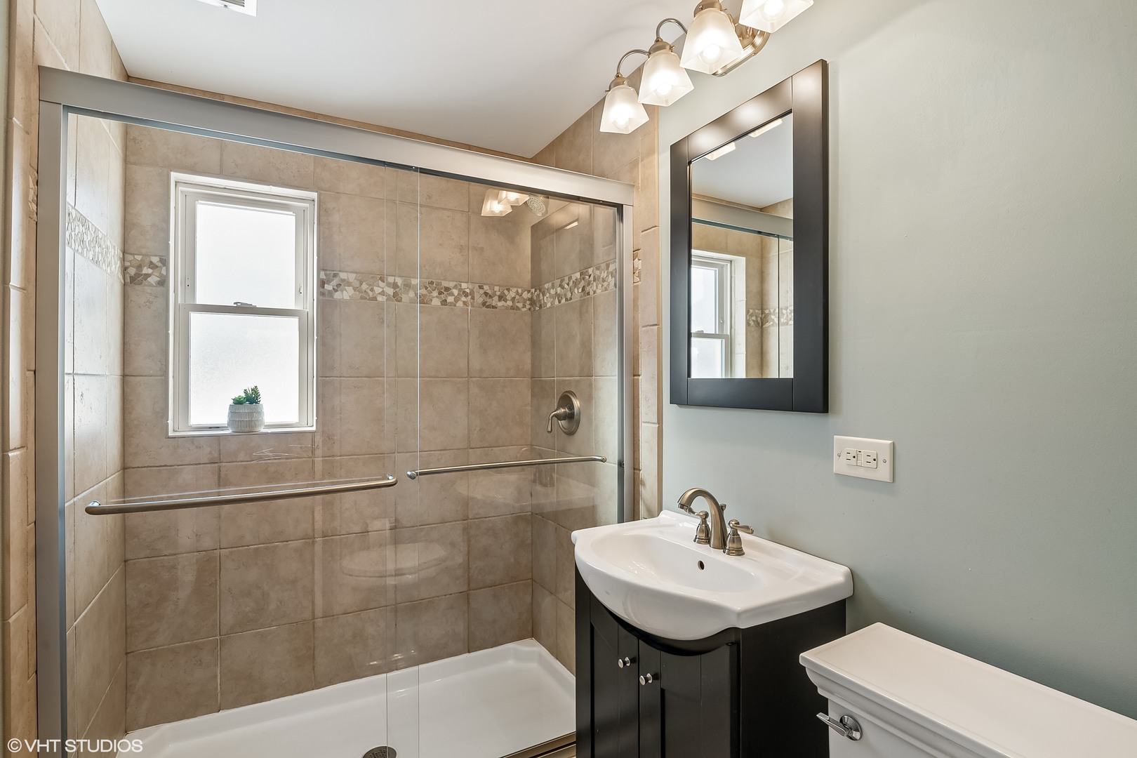 637 Second Avenue Libertyville, IL 60048 - Photo 15 of 22 a bathroom with a sink a toilet a mirror and shower