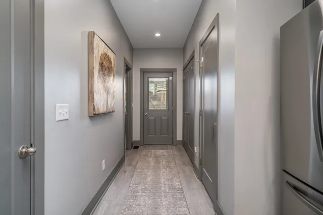 a view of a hallway with wooden floor