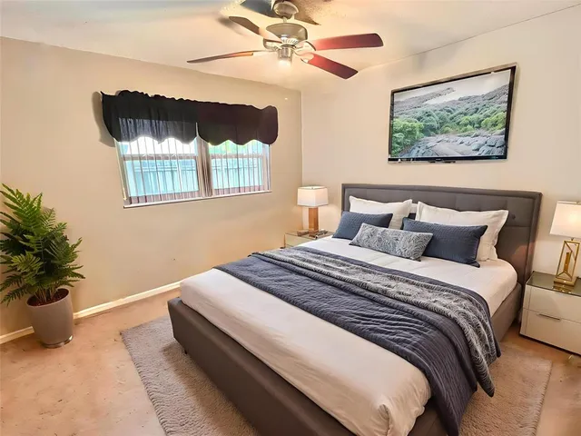 a bedroom with bed and a potted plant