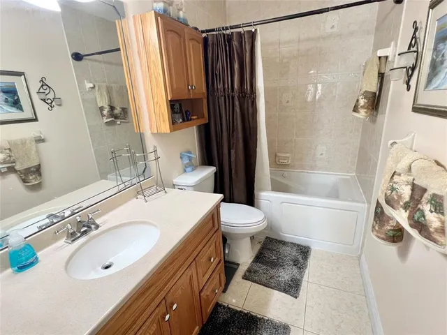 a bathroom with a sink toilet tub and shower