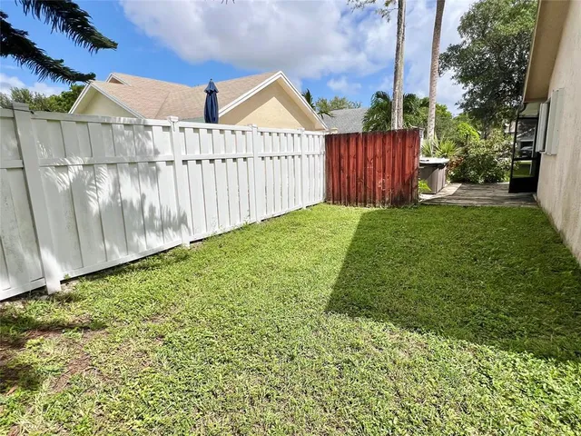 a view of a backyard with pathway